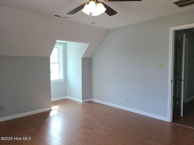 additional living space featuring lofted ceiling, a ceiling fan, visible vents, and baseboards