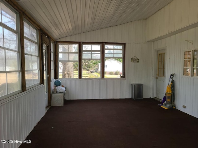 unfurnished sunroom featuring vaulted ceiling