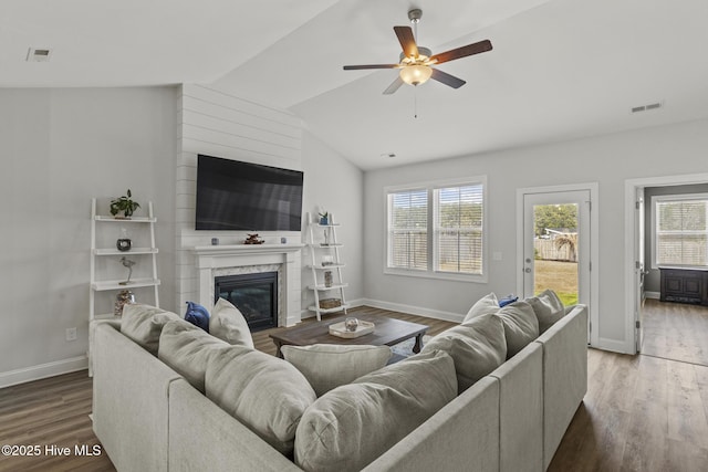 living area featuring visible vents, wood finished floors, a ceiling fan, and vaulted ceiling