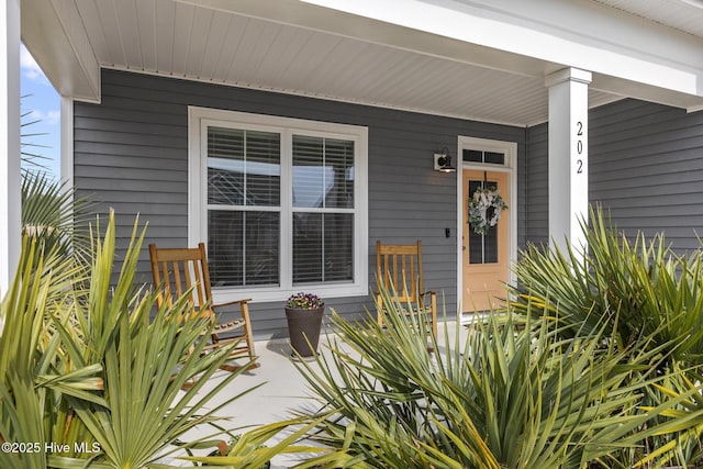 view of exterior entry with a porch