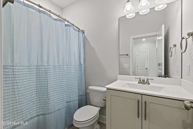 bathroom featuring vanity, toilet, and a shower with curtain