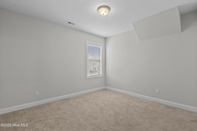 unfurnished room featuring visible vents, baseboards, and carpet flooring