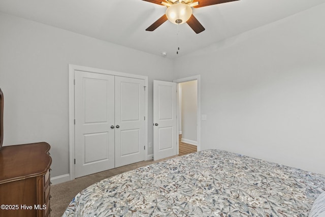 bedroom featuring ceiling fan, carpet, a closet, and baseboards