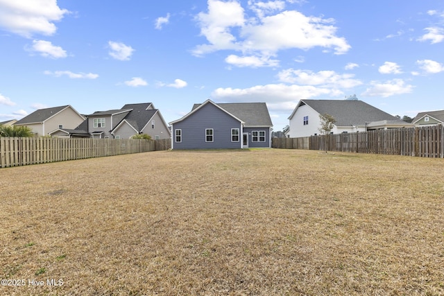 view of yard featuring a residential view and a fenced backyard