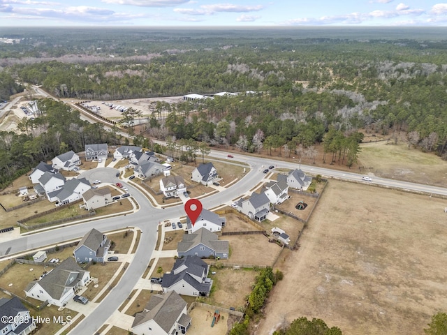 aerial view featuring a view of trees and a residential view