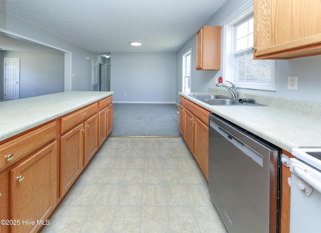 kitchen with baseboards, dishwasher, light countertops, a textured ceiling, and a sink