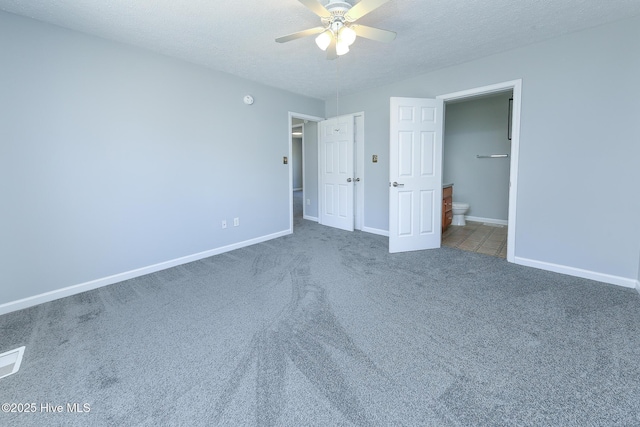 unfurnished bedroom with connected bathroom, carpet, baseboards, and a textured ceiling