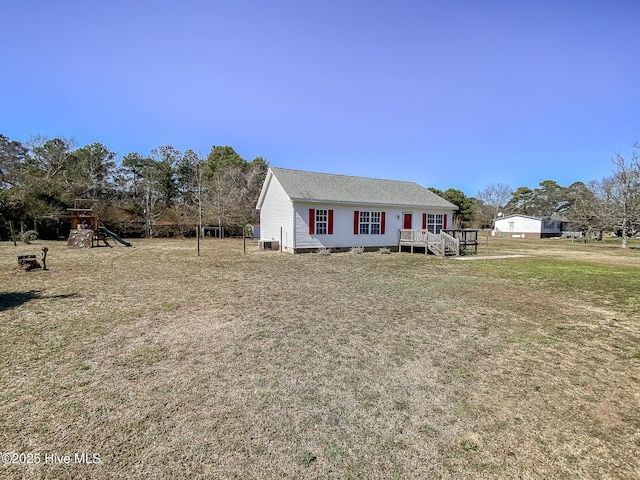 view of front of house featuring a front lawn and a playground