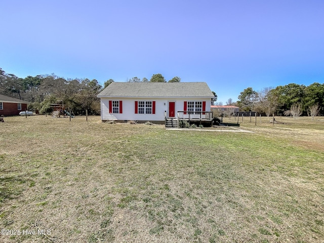 view of front of house with a deck and a front lawn