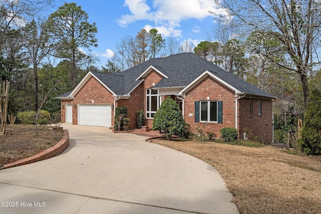 single story home featuring concrete driveway, a garage, brick siding, and roof with shingles