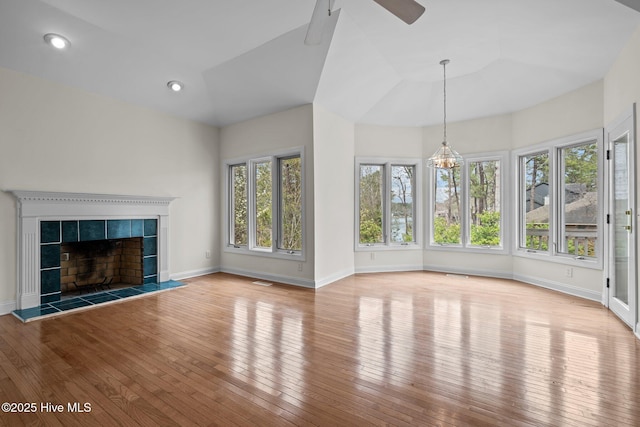 unfurnished living room with hardwood / wood-style floors, recessed lighting, a fireplace, baseboards, and ceiling fan