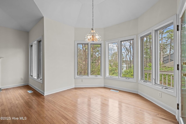 unfurnished sunroom with visible vents and a chandelier