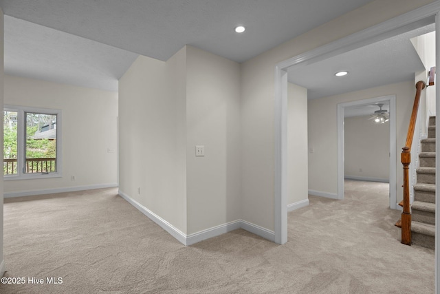 unfurnished room with baseboards, carpet floors, and stairway