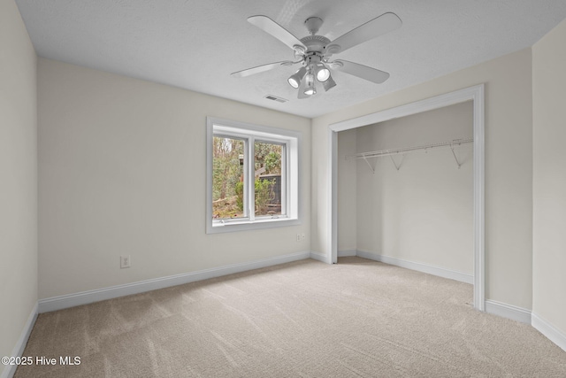 unfurnished bedroom with carpet flooring, baseboards, visible vents, and a closet