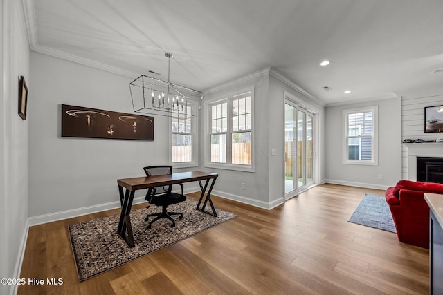 office with ornamental molding, baseboards, a healthy amount of sunlight, and wood finished floors