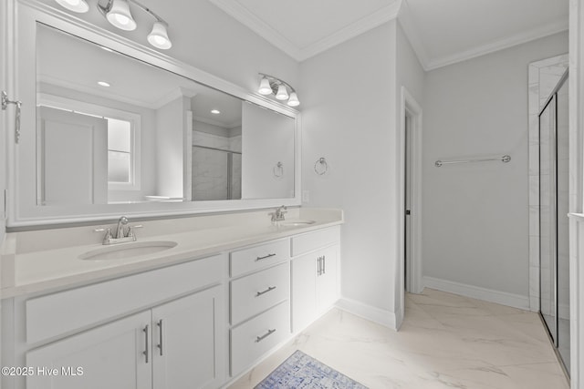 bathroom with baseboards, a stall shower, a sink, crown molding, and marble finish floor