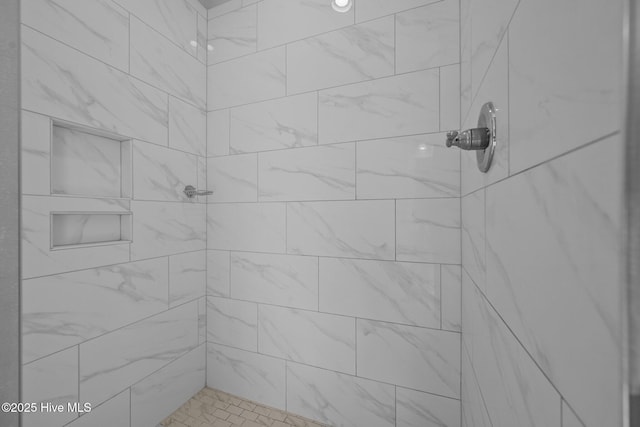 bathroom with tiled shower