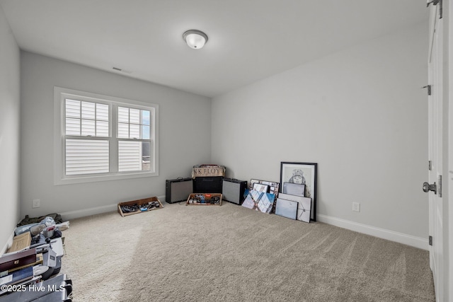 interior space featuring visible vents, baseboards, and carpet