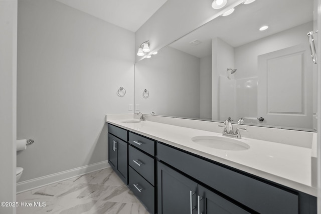 full bath featuring marble finish floor, a shower, baseboards, and a sink