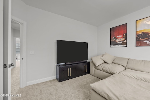 carpeted living area with baseboards