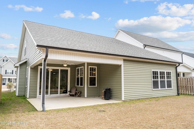 rear view of house featuring fence, a shingled roof, a ceiling fan, and a patio area