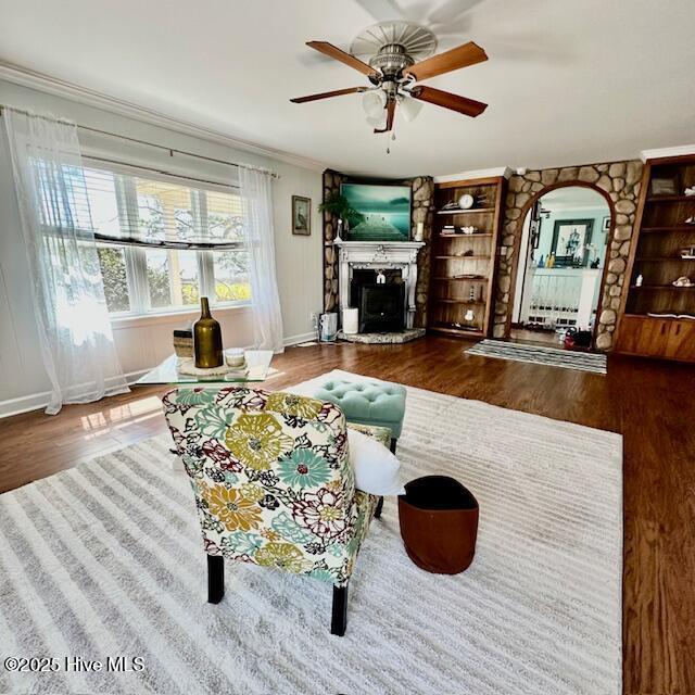 dining space featuring crown molding, wood finished floors, and ceiling fan