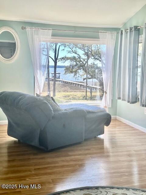 bedroom with baseboards, wood finished floors, lofted ceiling, and ceiling fan