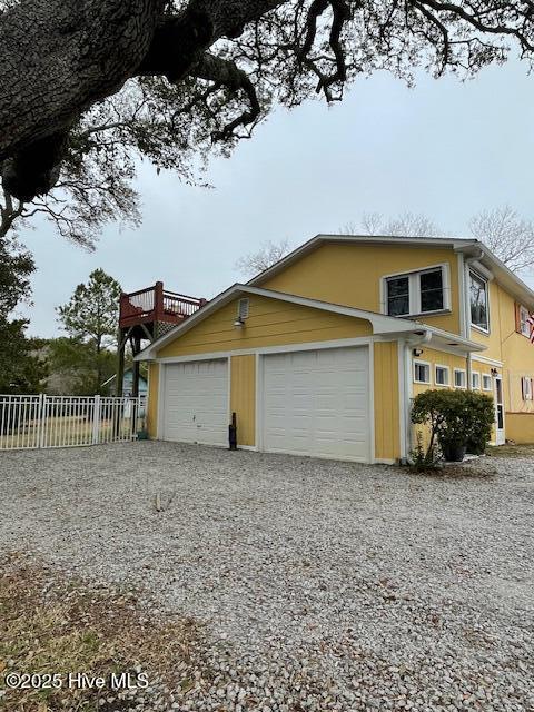 view of side of property featuring fence and a deck