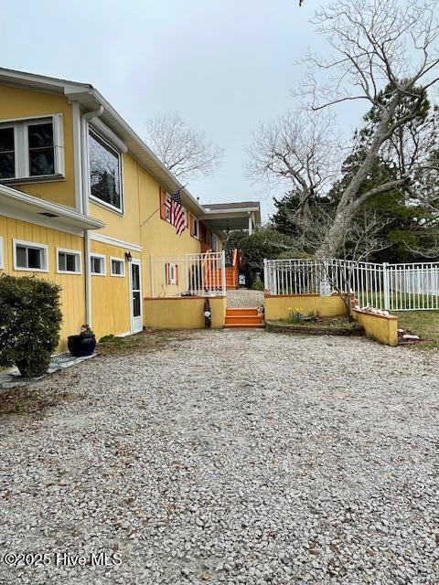 view of side of home with central AC unit and a deck