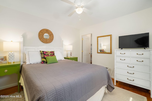 bedroom with wood finished floors, baseboards, and ceiling fan