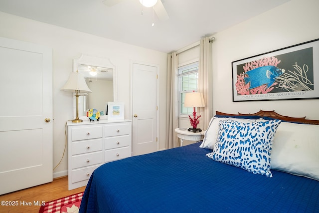 bedroom featuring light wood-type flooring and a ceiling fan