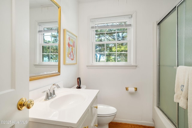 full bath featuring a healthy amount of sunlight, toilet, and vanity