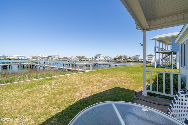 dock area with a yard and a water view