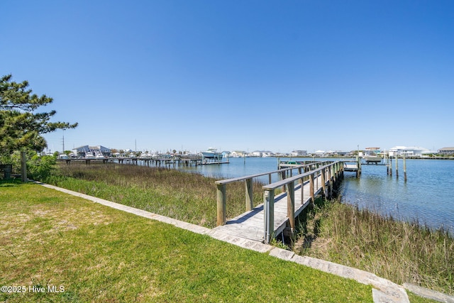 dock area featuring a water view and a lawn