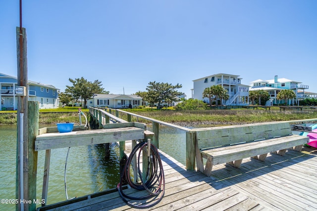 dock area featuring a residential view and a water view