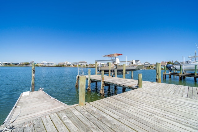 dock area featuring boat lift and a water view