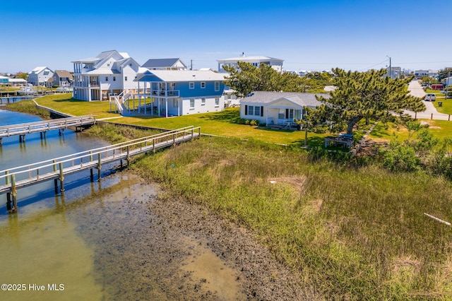 birds eye view of property featuring a water view and a residential view