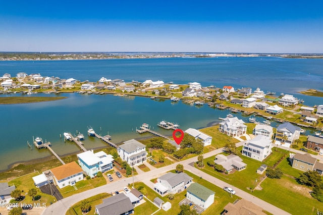 drone / aerial view featuring a residential view and a water view