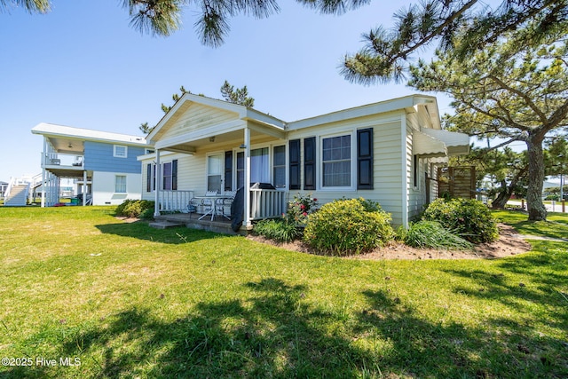 view of front of home with covered porch and a front yard