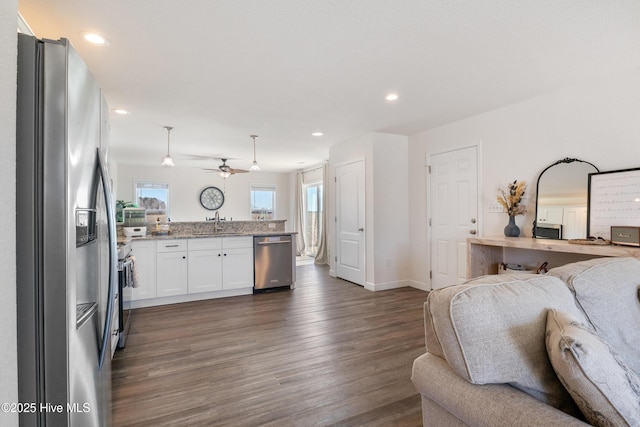 kitchen featuring a peninsula, dark wood-style floors, open floor plan, and stainless steel appliances