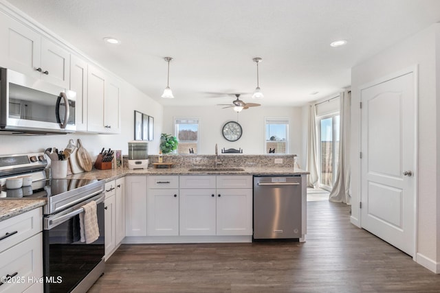 kitchen featuring ceiling fan, a peninsula, white cabinets, stainless steel appliances, and a sink