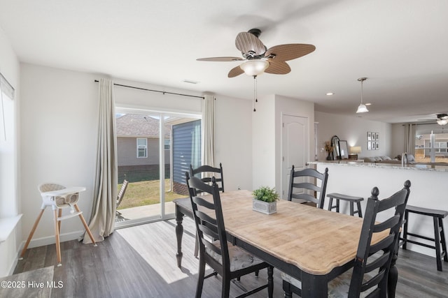 dining space with visible vents, baseboards, ceiling fan, and dark wood-style flooring