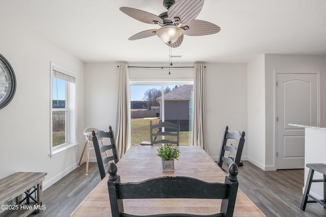 dining area with baseboards, ceiling fan, and wood finished floors