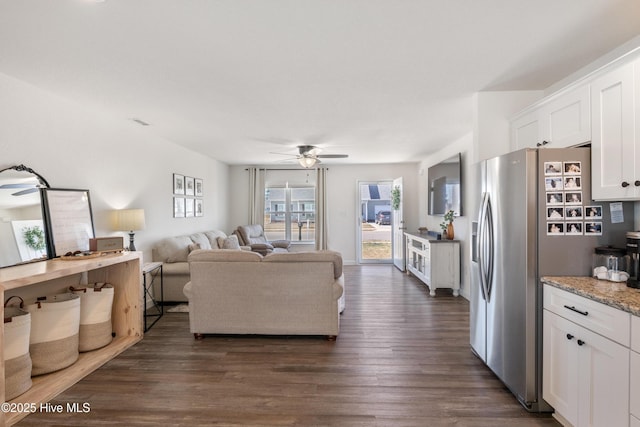 living area with a ceiling fan, dark wood-style floors, and visible vents