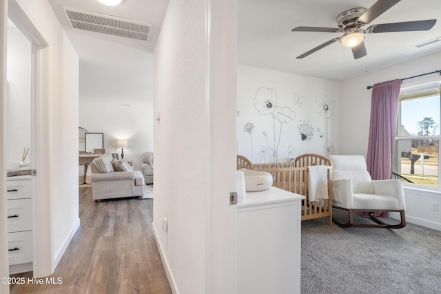 bedroom featuring a ceiling fan, wood finished floors, baseboards, and visible vents