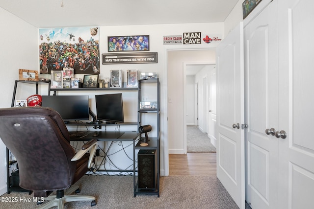 home office with baseboards and carpet floors