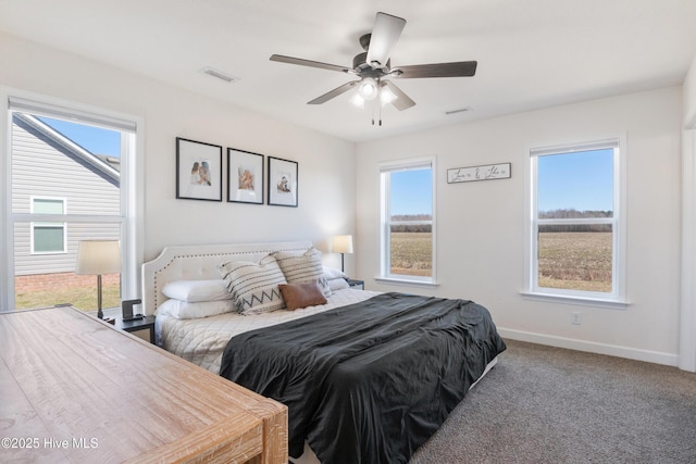 bedroom featuring baseboards, multiple windows, a ceiling fan, and carpet flooring