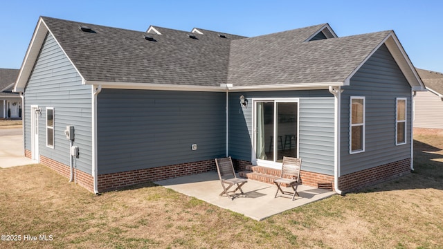 back of house featuring entry steps, a patio, a lawn, and roof with shingles