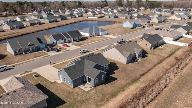 birds eye view of property with a residential view and a water view