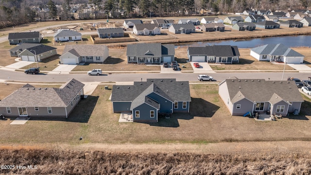 drone / aerial view with a residential view and a water view